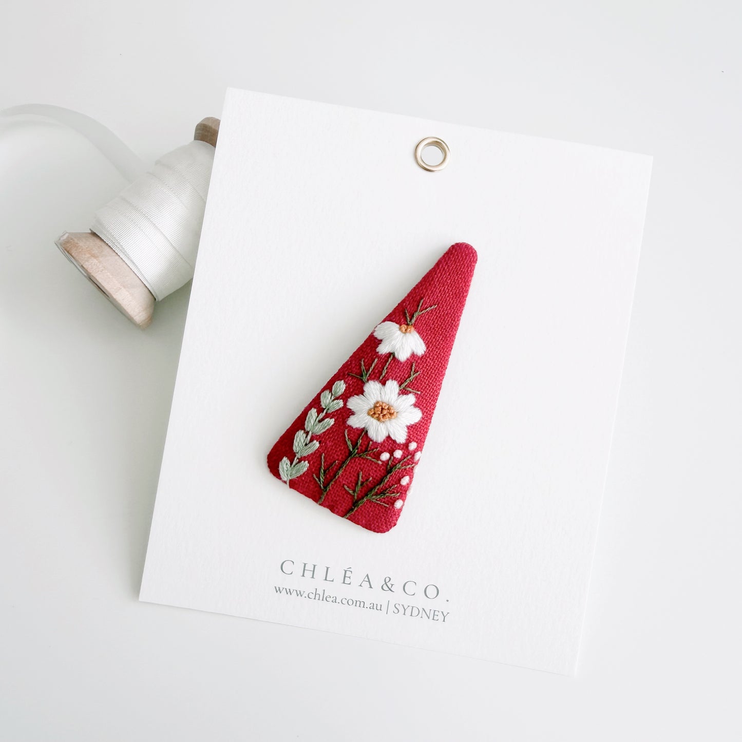 Embroidered Daisy On Red Linen