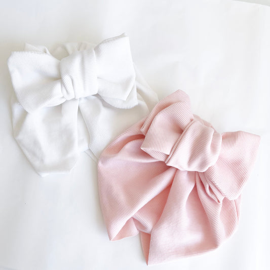 Pre-tied Baby Turban  available in white and pink colour. Beautiful hair bow for everyday wear and special occasions such as wedding, flower girl, baptism, christening, birthday outfit and photoshoot.