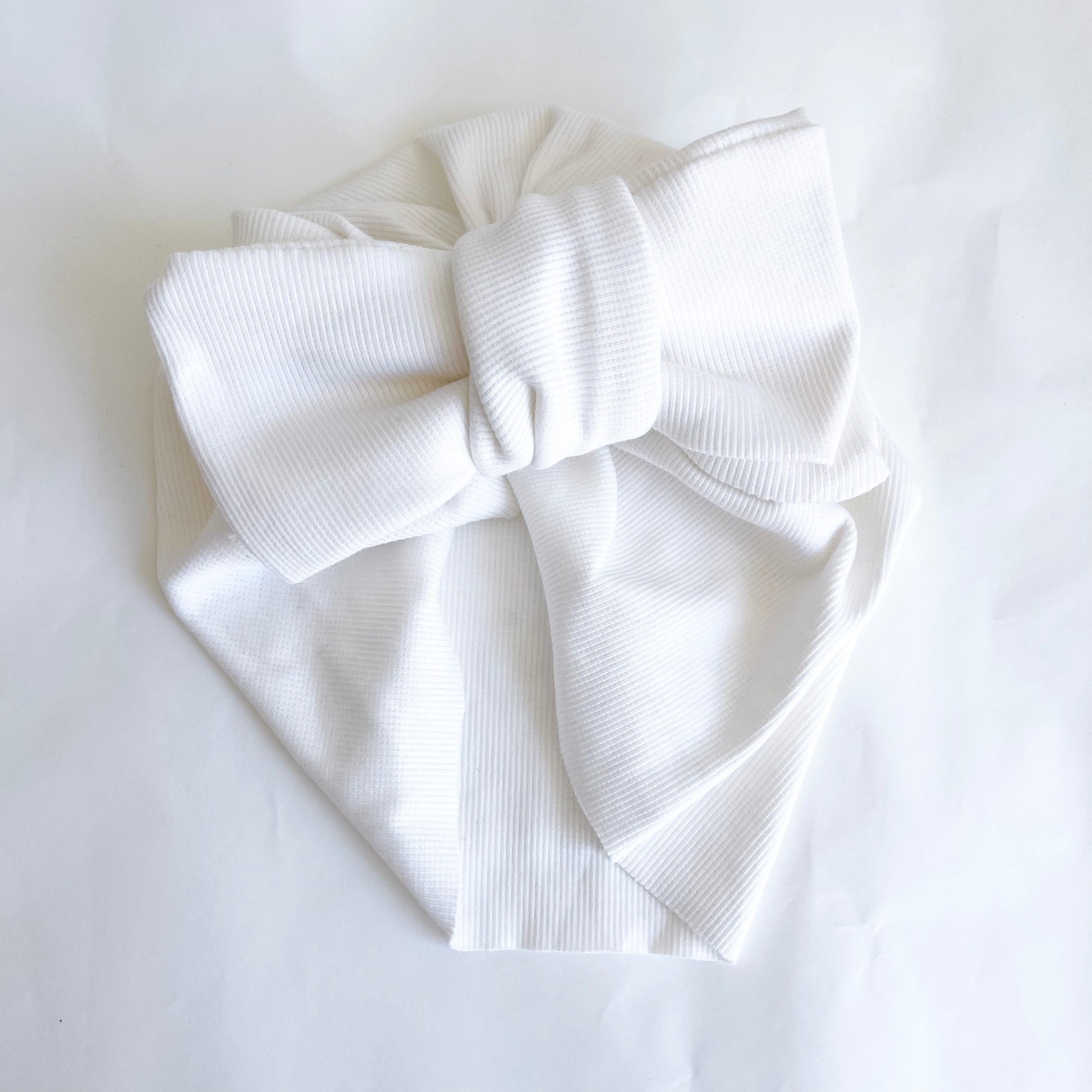Pre-tied Baby Turban  available in white colour. Beautiful hair bow for everyday wear and special occasions such as wedding, flower girl, baptism, christening, birthday outfit and photoshoot.